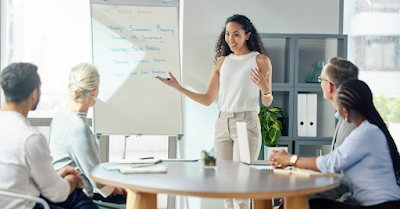Woman speaking to colleagues about Community Health Assessments (CHAs)