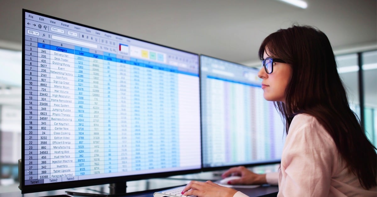 Health information professional at computer managing and analyzing patient data